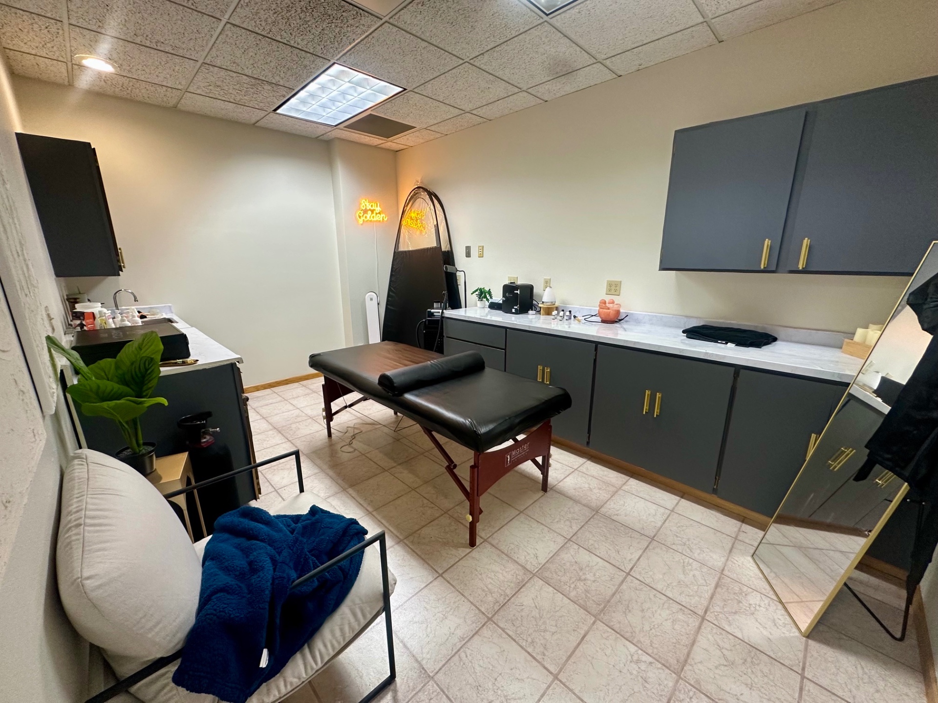 Exchange Building Suite 120 — adjoining treatment room with built-in cabinetry and sink